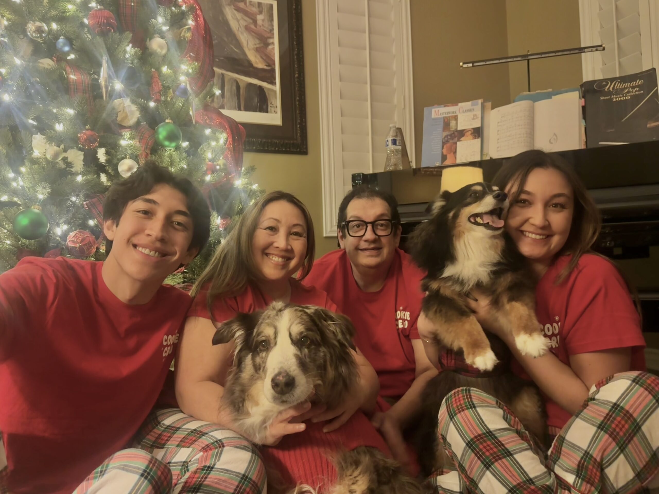 Dr. Meerweis Stanisai with his family and two Australian Shepherds